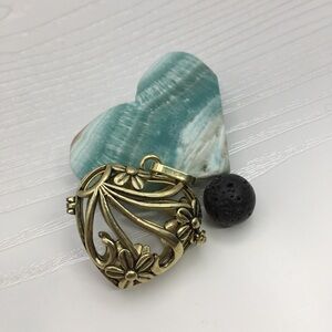 Heart & Flower Aromatherapy Brass tone Locket.  Lava stone included.